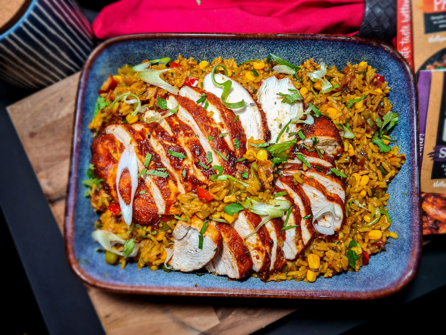 Large dish with paella rice and glazed chicken breast