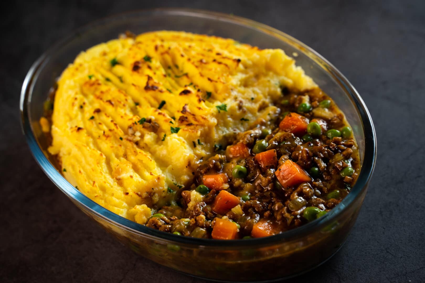 Glass dish with classic shepherd's pie topped with mash potato